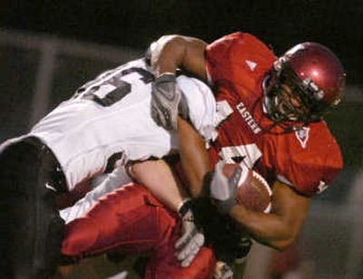
EWU's Alexis Alexander takes a hit from Michael Dorsey. 
 (Christopher Anderson / The Spokesman-Review)