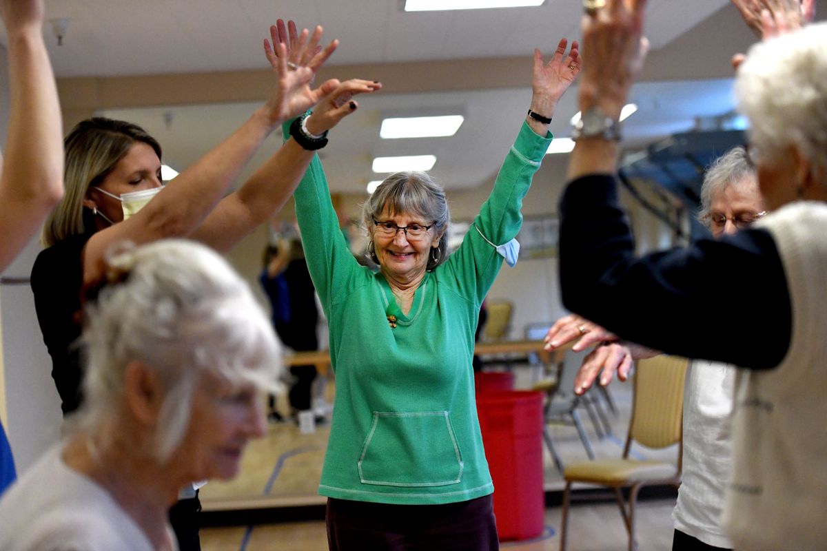 Charlotte Marie Bouley, center, cheers with fellow players at Touchmark South Hill after basketball camp on March 16.  (Kathy Plonka/The Spokesman-Review)