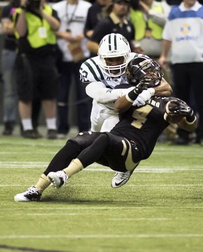 Ohio Bobcats linebacker Marcus Collins (52) tackles Idaho Vandals running back Calvary Pugh (4) during the first half of a NCAA college football game, Thursday, Sept. 3, 2015, at the Kibbie Dome in Moscow, Idaho. (Colin Mulvany / The Spokesman-Review)