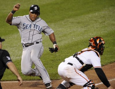 Seattle’s Adrian Beltre scores past Orioles catcher Gregg Zaun.  (Associated Press / The Spokesman-Review)