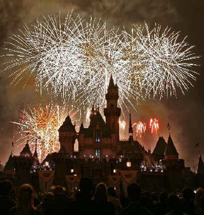 
Fireworks explode behind Sleeping Beauty's Castle during the premiere of 