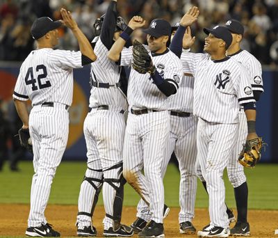 Yankees players celebrate after completing a series sweep of the Twins. (Associated Press)