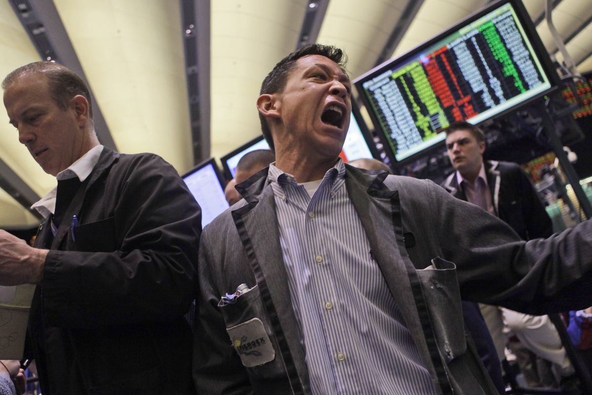 Traders work the crude oil options pit at the New York Mercantile Exchange on Wednesday in New York. Oil prices continue to climb as forces loyal to Moammar Gadhafi violently clashed with protesters who have expanded their control over the country. (Associated Press)