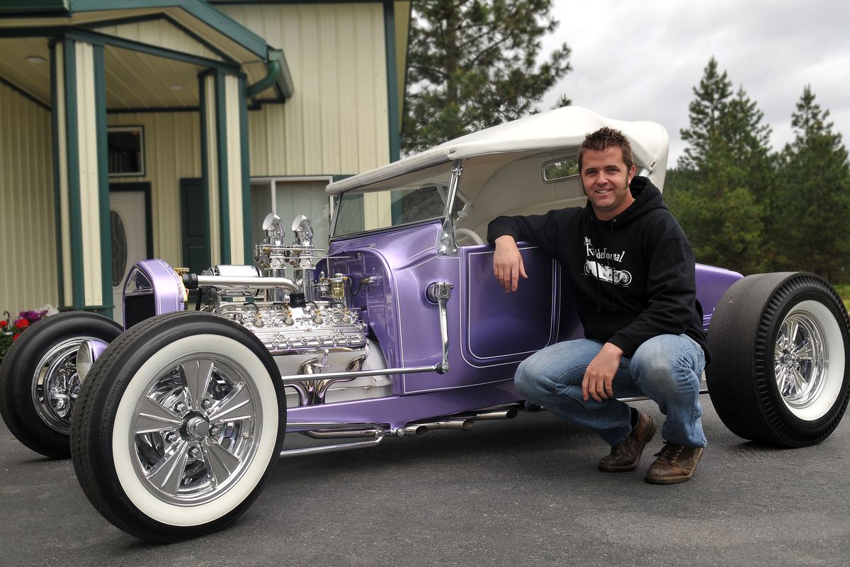 Russ Freund is seen with his latest car outside the family shop Thursday in Newman Lake. His father, Claude Freund, who died in April, helped him build the car. Russ’ father was well known in hot rod circles as a master builder of world-class cars at the Newman Lake shop. (Jesse Tinsley)