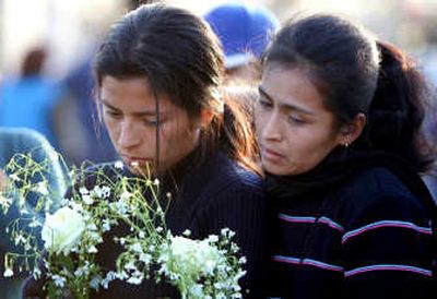
Women attend the burial of an earthquake victim on Friday in Pisco, Peru. At least 510 people were killed in Wednesday's quake. Associated Press
 (Associated Press / The Spokesman-Review)