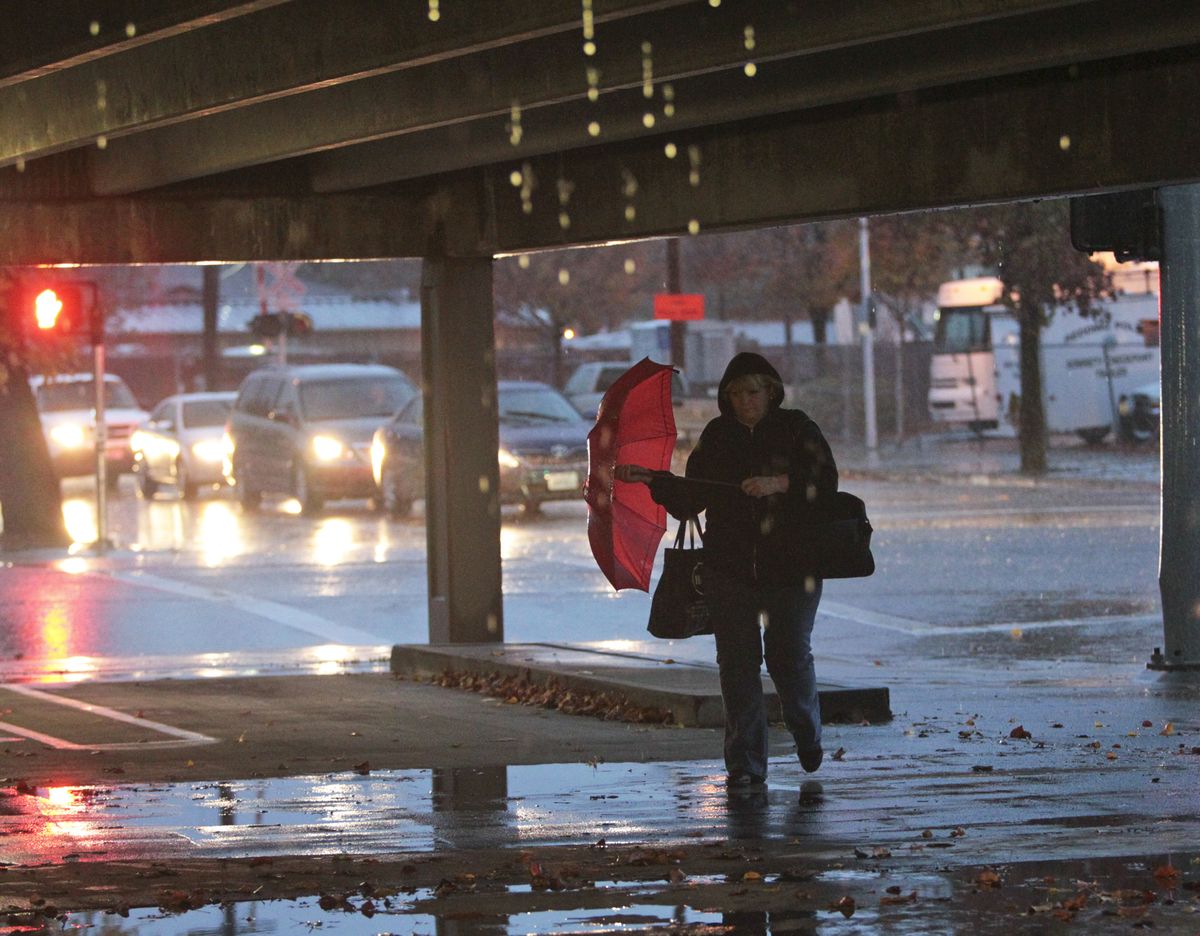 Bobbi Berg of Redding walks to her car in the parking structure after work Thursday, Nov. 29, 2012 in downtown Redding, Calif. The brunt of a winter storm struck Thursday afternoon with high winds and heavy rain. Rain is expected to continue to fall on the north state through Sunday. (Andreas Fuhrmann / The Record Searchlight)