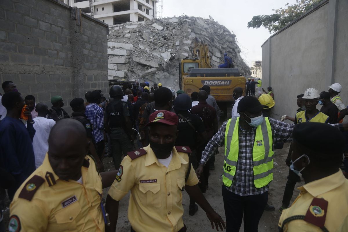 Rescue workers are seen at the site of a collapsed 21-story apartment building under construction in Lagos, Nigeria, Monday, Nov. 1, 2021. At least two people were killed and dozens more remain missing after the collapse of a 21-story apartment building being built in an upscale area of Nigeria
