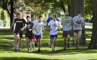 
Leon Dean and Adam Tyler (front left and right in white shirts) head the pack as the North Central cross country runners warm up at Audubon Park. 
 (Christopher Anderson / The Spokesman-Review)