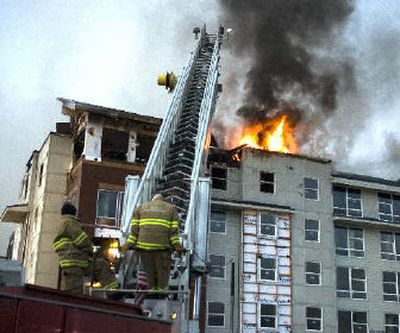 
Because it was to dangerous to fight the fire inside the building, Spokane firefighters used water cannons mounted on truck ladders. 
 (Colin Mulvany / The Spokesman-Review)