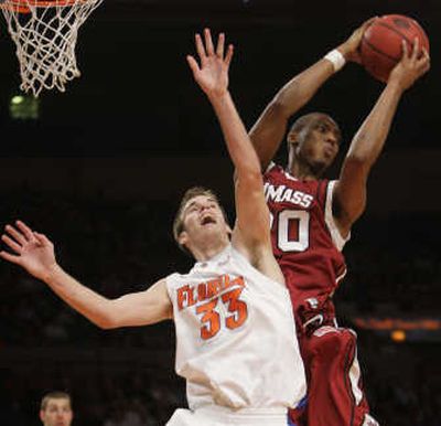 
Massachusetts' Dante Milligan snags a rebound away from Florida's Nick Calathes. Associated Press
 (Associated Press / The Spokesman-Review)