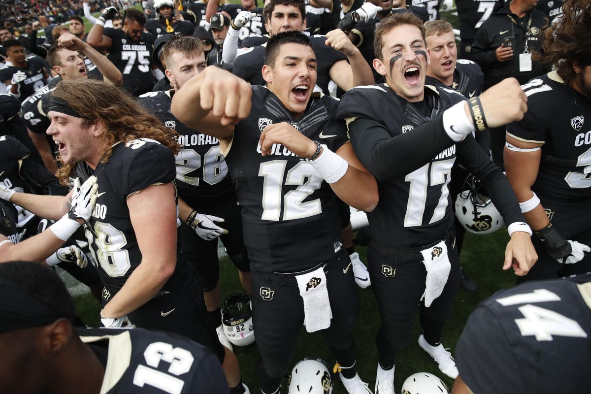 Colorado quarterback Steven Montez, left, joins quarterback Josh Goldin and their teammates in singing the school song after the second half of an NCAA college football game against Arizona State Saturday, Oct. 6, 2018, in Boulder, Colo. Colorado won 28-21. (David Zalubowski / AP)