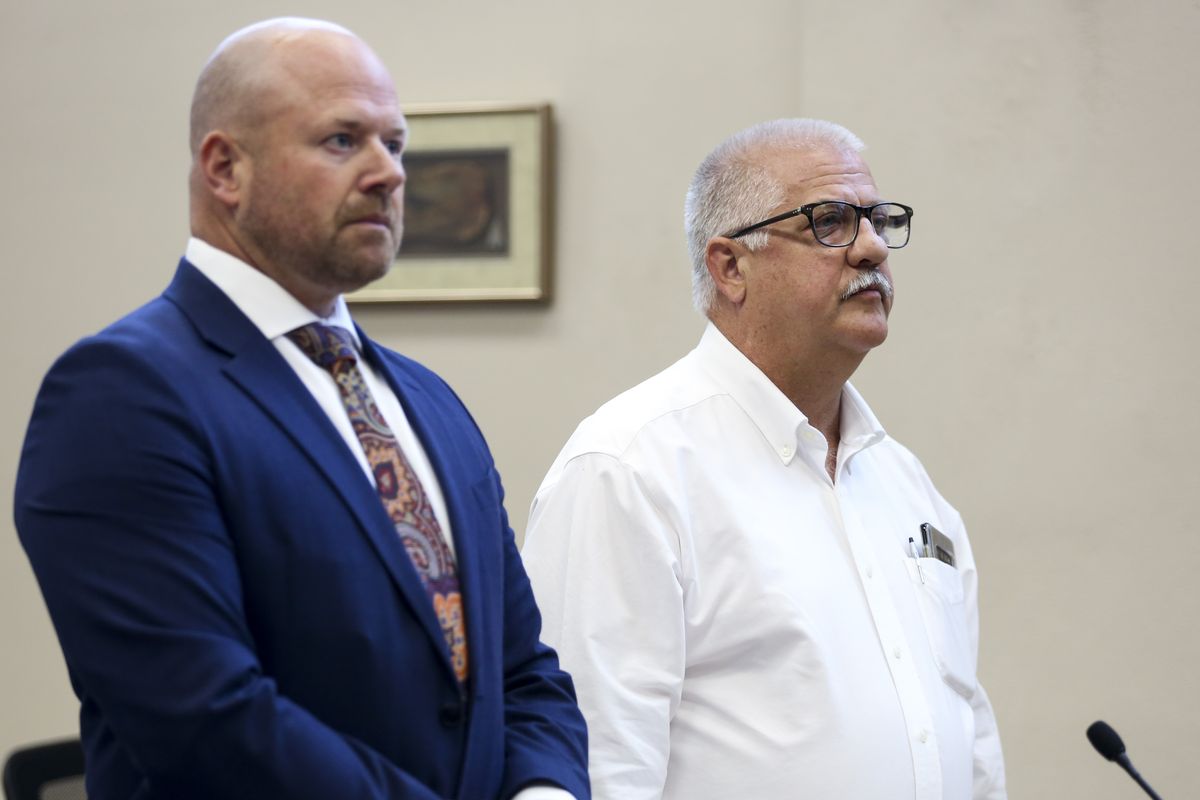 Former Oregon state Rep. Mike Nearman, right, stands with his attorney during a hearing, Tuesday, July 27, 2021, at the Marion County Circuit Court in Salem, Ore. Nearman, who was expelled for letting violent, far-right protesters into the state Capitol pleaded guilty Tuesday to one count of official misconduct. He was sentenced to 18 months probation, during which he will need to complete 80 hours of community service and is banned from the Capitol building and grounds. He will also pay $200 in court fees and $2,700 to the Oregon Legislative Administration for damages done during the Dec. 21 riot.  (Abigail Dollins)