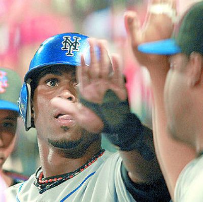 
New York Mets' Jose Reyes is congratulated in the dugout after scoring in the fourth inning. 
 (Associated Press / The Spokesman-Review)