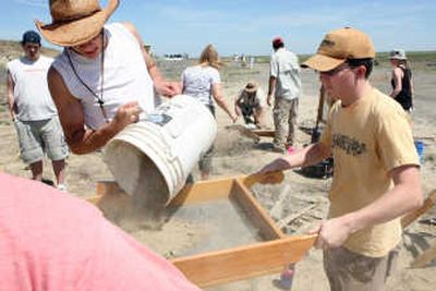 
Kamiakin High School students Joseph Morgan, 18, left, and John Coppinger, 16, sift dirt at a mammoth excavation site near Kennewick on May 17. Kamiakin students were invited to join Central Washington University students on the archaeological dig. Associated Press
 (Associated Press / The Spokesman-Review)