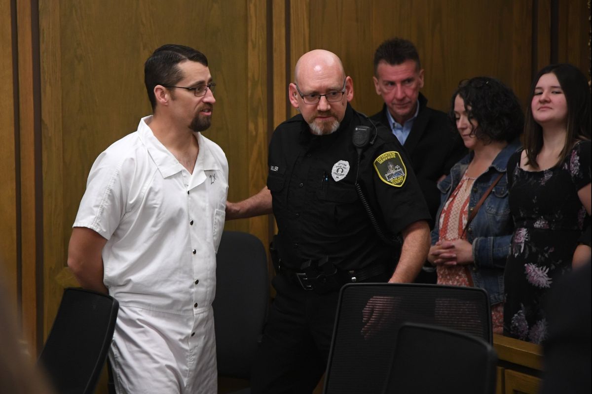 Ex-police officer Nathan Nash, left, says goodbye to his family as he is led away after being sentenced to more than 14 years in prison on two counts of rape Thursday at the Spokane County Courthouse.  (Jesse Tinsley/THE SPOKESMAN-REVIEW)