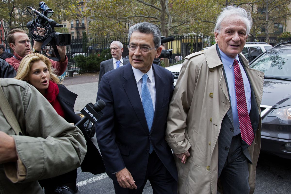 Former Goldman Sachs and Procter & Gamble Co. board member Rajat Gupta, center, arrives at court in New York Wednesday, Oct. 24, 2012. Gupta is to be sentenced after being found guilty insider trading by passing secrets between March 2007 and January 2009 to a billionaire hedge fund founder who used the information to make millions of dollars. At right is Gupta
