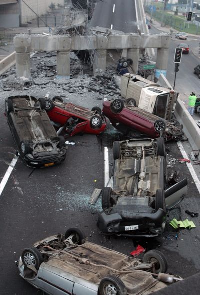 A highway collapsed during Saturday’s quake, overturning vehicles near Santiago, Chile. (Associated Press)