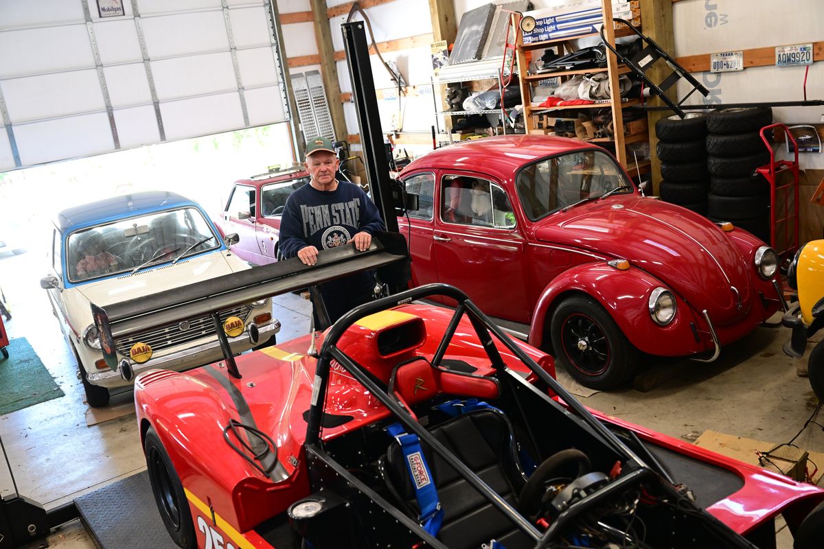 Rich Gaffey poses amid his collection as he leans on the wing of his Hayabusa-powered Radical race car June 22 at his home in Spokane.  (Tyler Tjomsland/The Spokesman-Review)