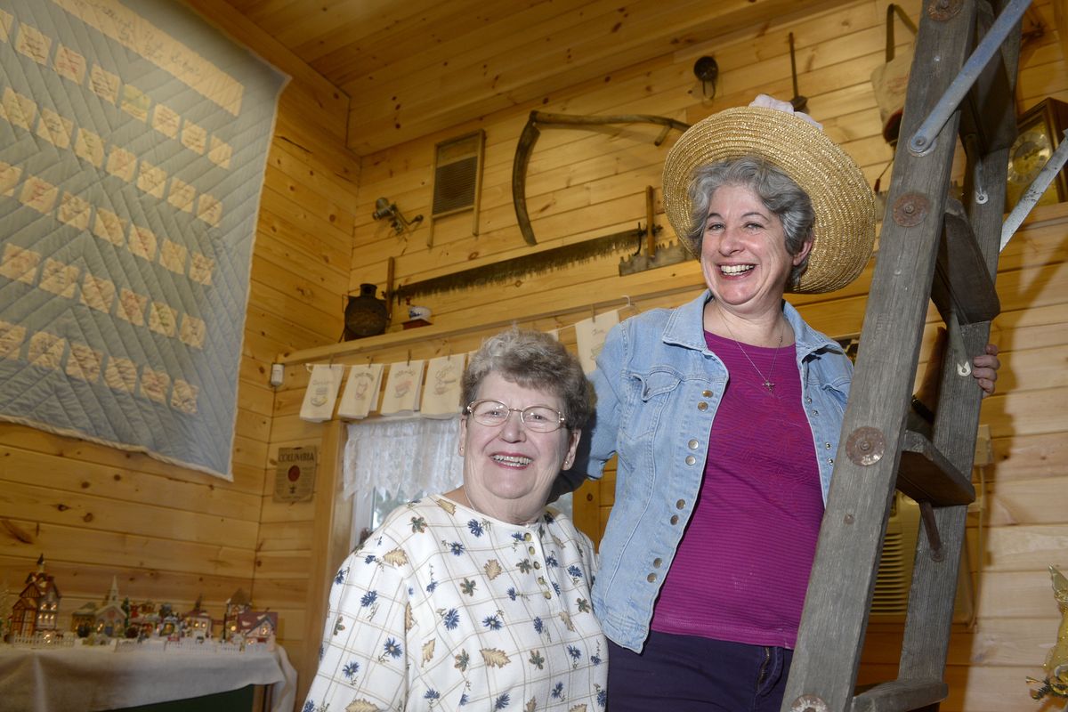 Carol Elliott, left, and Elaine Rising are members of a group focused on preserving Valleyford history. They are shown at On Sacred Grounds, a coffee bar run by Rising, on Dec. 20. (Jesse Tinsley)