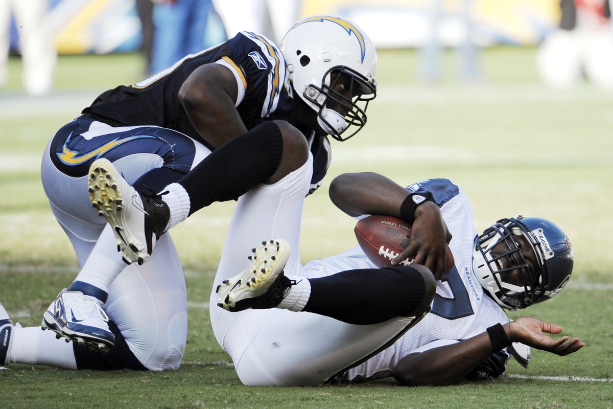 Seattle Seahawks quarterback Tarvaris Jackson, right, lies on the field after being sacked by San Diego Chargers linebacker Darryl Gamble during the first half of their preseason NFL football game at Qualcomm Stadium, Thursday, Aug. 11, 2011, in San Diego. (Denis Poroy / Fr59680 Ap)