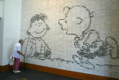 
A visitor looks over the Charlie Brown and Lucy tile mural at the  Charles M. Schulz Museum and Research Center. The mural, created by Japanese artist Yoshiteru Otani, covers an entire wall and is composed of 3,588 
