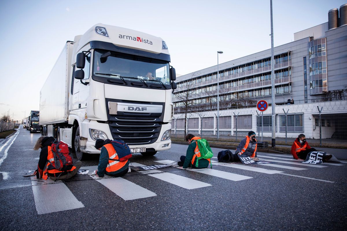 Climate activists of the group Uprising of the Last Generation glued their hands to a crosswalk to block an access road to the cargo area from Munich Airport in Munich, Germany, on Wednesday.  (Matthias Balk)