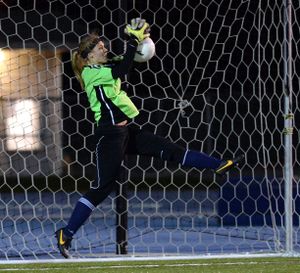 Mt. Spokane's goalie Shannon McReynolds grabs a high shot in the first half of the 3A district game Wednesday, Oct. 30, 2013 at Spokane Falls Community College. (Jesse Tinsley / The Spokesman-Review)