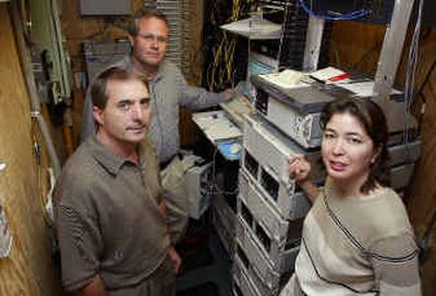 Ben Bicknell, left, chief of U.S. operations for Arizona-based Tectura Corp., which sells Microsoft software to small businesses, stands with Karen School, right, chief financial officer for the Edmond, Wash.-based travel company Rick Steves' Europe Through the Back Door, and Brooke Burdick, upper left, the travel company's communications manager on Thursday. (AP / The Spokesman-Review)