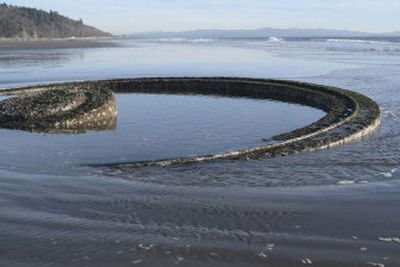 
The remnants of a coastal defense cannon mount protrudes out of the sand on the beach at North Cove, Wash. 
 (Photo courtesy of Rick Higgns / The Spokesman-Review)