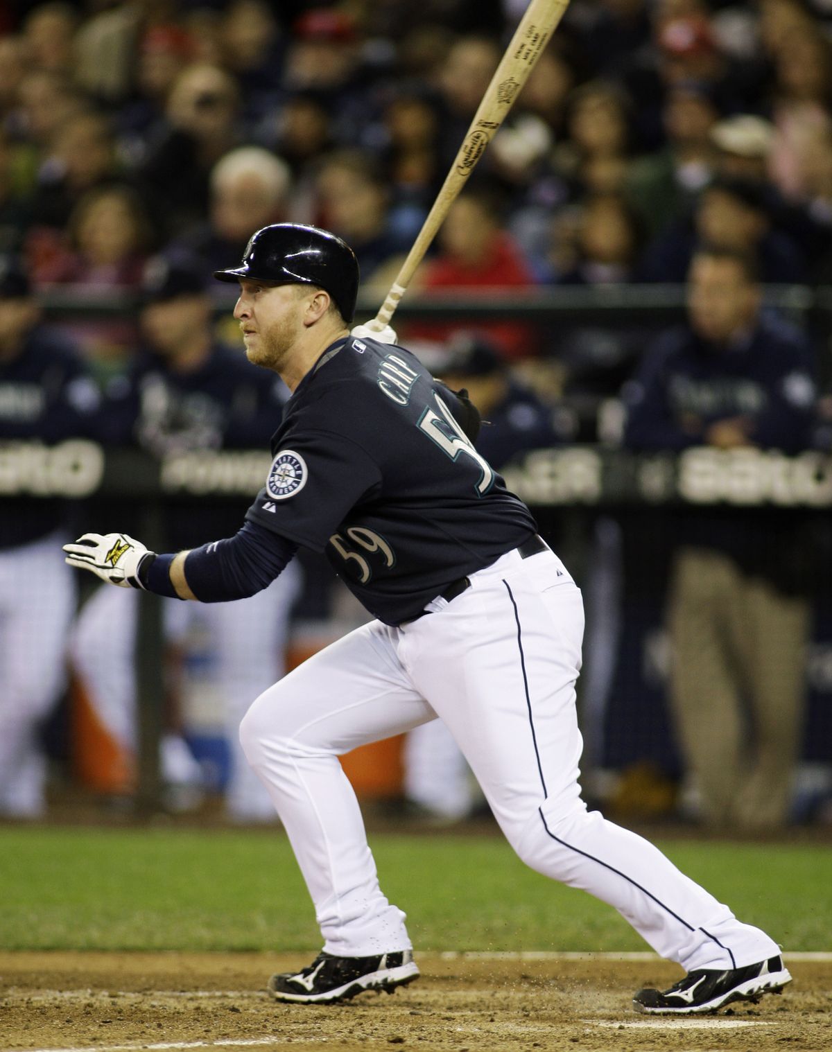 Associated Press Seattle’s Mike Carp hits a two-run single in the fourth inning of Friday’s game. (Associated Press / The Spokesman-Review)