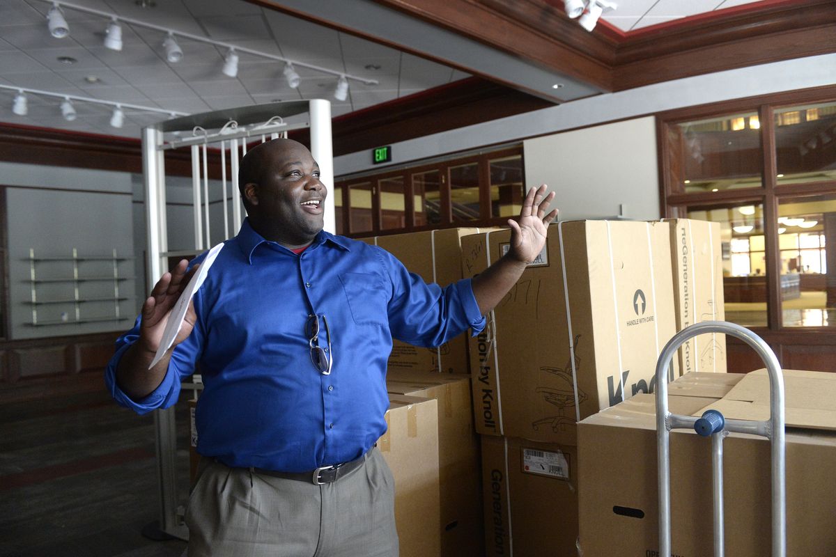 Assistant Athletic Director Devon Thomas stands Tuesday next to boxes of office chairs and describes the new Washington State University store and ticket outlet that will fill a commercial space in downtown Spokane and open in early September. The store will sell apparel and tickets and be a place for Cougar fans to hang out and talk sports. (Jesse Tinsley)