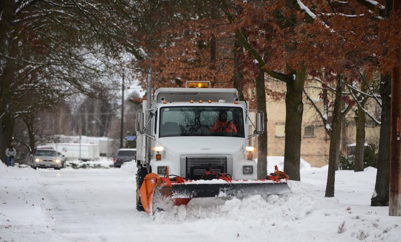 A plow removes snow from East Dalton Avenue in Millwood Dec. 27, 2016, after overnight snows of 2 to 4 inches around the Spokane region. (Jesse Tinsley / The Spokesman-Review)