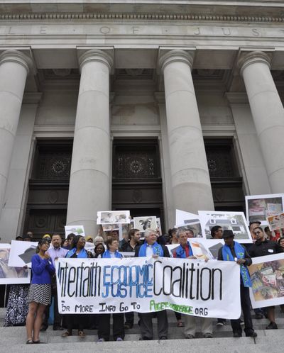 OLYMPIA -- Supporters of a $15 minimum wage in the city of Seatac gather outside the Supreme Court building after the court heard arguments of whether the wage should apply at SeaTac Airport. (Jim Camden)