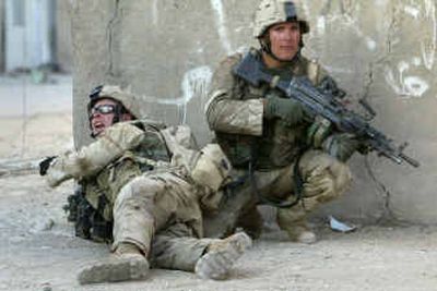 
U.S. Army soldiers direct fire Monday in the streets of Najaf, where sporadic but heavy fighting continued through the day as troops closed in on al-Sadr's militia fighters. 
 (Associated Press photos / The Spokesman-Review)
