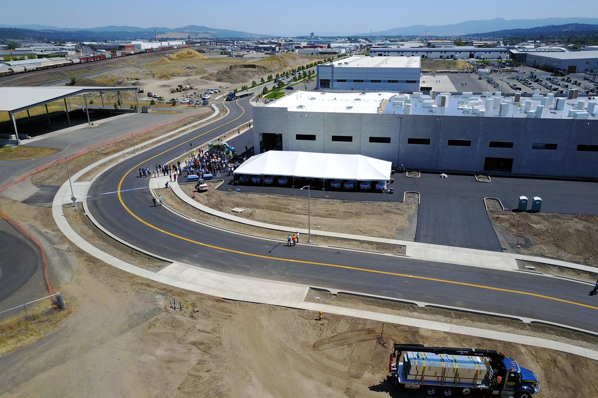 Dignitaries gather to celebrate the opening of the new arterial through the Playfair Commerce Park, Tuesday, July 11, 2017. The road winds around multi-use industrial buildings built by businessman Larry Stone. Critical to getting the road approved was to open the railroad underpass at Altamont on the west end of the 64-acre commer park. (Jesse Tinsley / The Spokesman-Review)