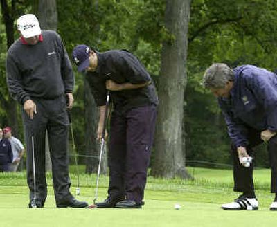 
Tiger Woods tries out the long-shafted putter belonging to Fred Couples, right, as Mark O'Meara, left, watches during a practice round prior to last year's U.S. Open.Tiger Woods tries out the long-shafted putter belonging to Fred Couples, right, as Mark O'Meara, left, watches during a practice round prior to last year's U.S. Open.
 (Associated PressAP / The Spokesman-Review)