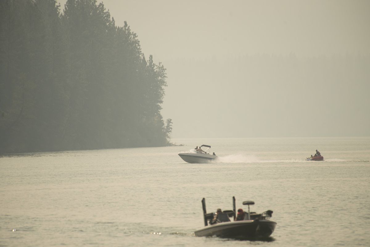Boaters enjoy Long Lake in the midst of smoke that returned to the Spokane area Sunday. (Jesse Tinsley)