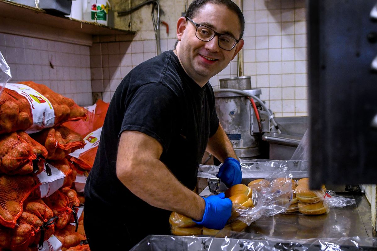 Dick’s Hamburgers employee Tony Swisher opens packages of buns on Thursday, Nov. 18, 2021. He was able to find employment through Skils’kin, a local non-profit organization focused on individual supported employment and community inclusion for people with disabilities.  (kathy plonka)