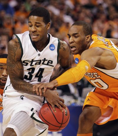 Tennessee’s J.P. Prince, right, fouls Michigan State’s Korie Lucious in the first half. (Associated Press)