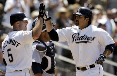 Padres’ Adrian Gonzalez, right, celebrates after his solo home run Thursday.  (Associated Press / The Spokesman-Review)