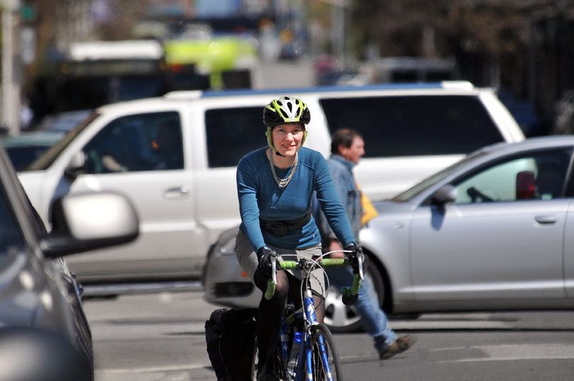 Barb Chamberlain, executive director of Washington Bikes, never balked at riding her bike in her professional clothes, even a skirt. This is a picture from May 9, 2011 in Spokane, when she still lived in town, convincing others to ride a bike. She was a driving force behind Spokane's Bike to Work week, but promotes cycling statewide. (Jesse Tinsley)