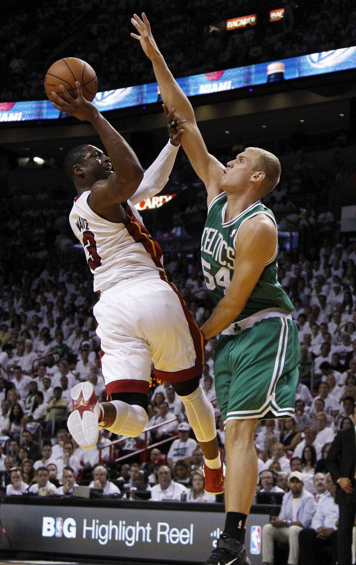 Heat’s Dwyane Wade shoots as Greg Stiemsma defends. (Associated Press)