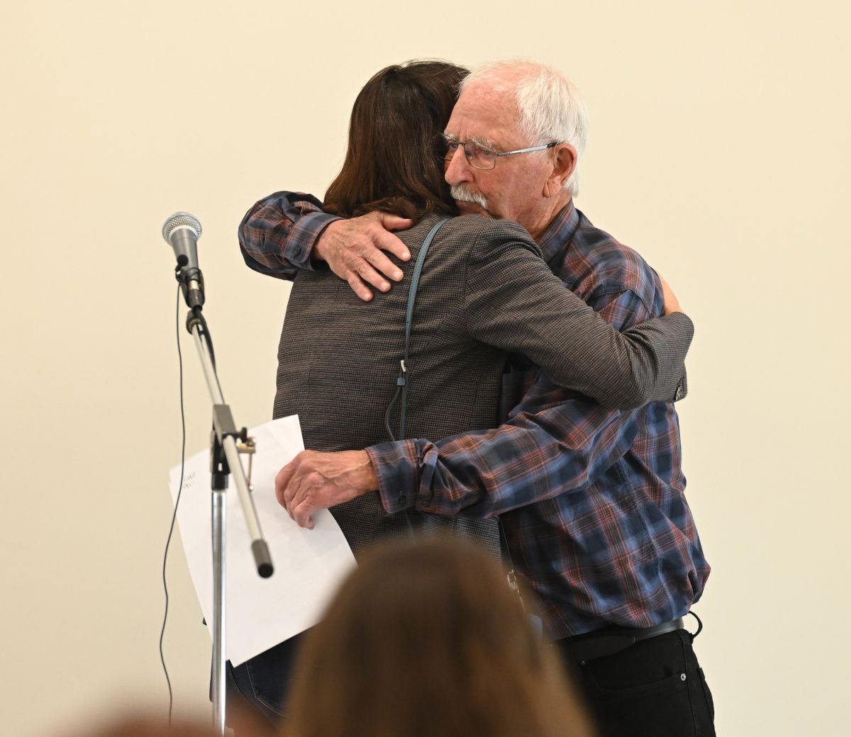 Malden Mayor Dan Harwood, right, hugs Shelly O’Quinn of the Innovia Foundation, which has helped in various ways with the town’s recovery since wildfires that took more than 60 houses on Labor Day 2020. Officials cut the ribbon on the new community building Thursday in Malden, Wash.  (Jesse Tinsley/THE SPOKESMAN-REVIEW)