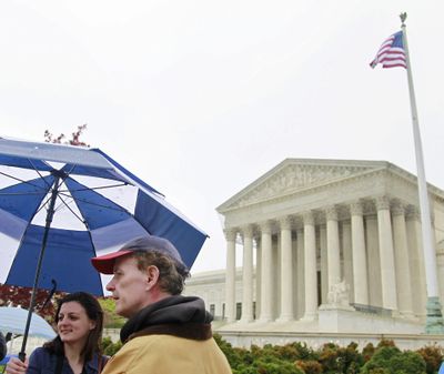 Monica Haymond, of Pasadena, Calif., and Tom Brennan, of Rochester, N.Y., stand in front of the Supreme Court on Saturday, hoping to get tickets to watch the opening arguments on the constitutionality of President Barack Obama’s health care overhaul Monday. (Associated Press)