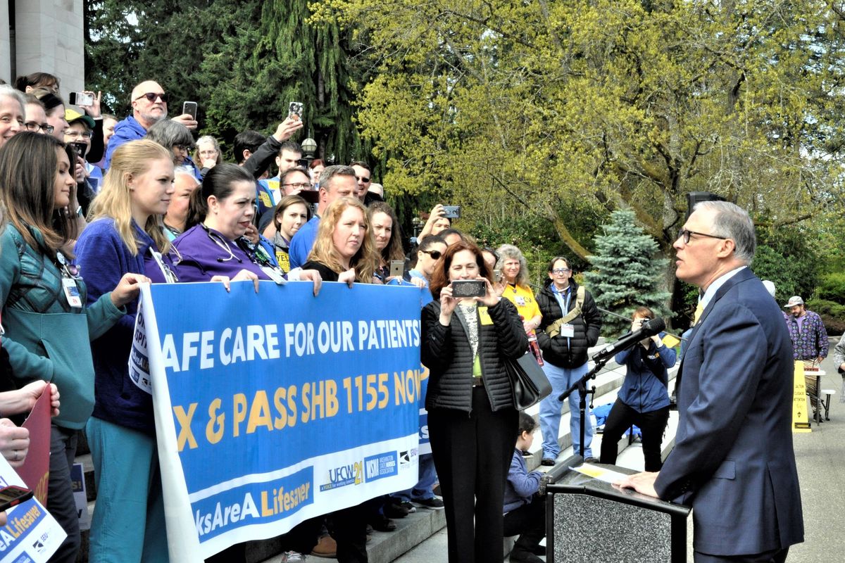 Washington Gov. Jay Inslee tells nurses and medical technicians rallying on the steps of the Legislative Building in Olympia on Wednesday  that a bill mandating rest and meal breaks for them in hospitals will protect them, their families and the patients under their care. The bill later passed both houses and will be sent to him for his signature. (Jim Camden / The Spokesman-Review)