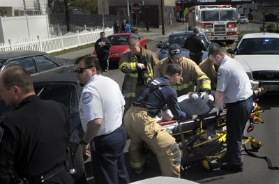 Spokane firefighters, police and AMR crews respond to a multiple-car accident at Second and Sunset on Tuesday. Budget cuts next year could result in firefighter layoffs.  (Christopher Anderson / The Spokesman-Review)