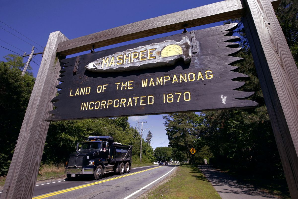 A wooden sign advises motorists of the location of Mashpee Wampanoag tribal lands, June 25, 2018, in Massachusetts. The tribe scored a major victory in its years long battle to preserve its reservation in December 2021, but it doesn