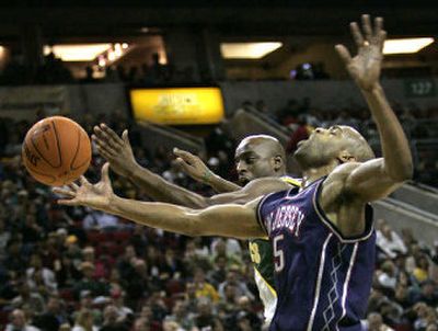 
Seattle's Damien Wilkins, back, and New Jersey's Vince Carter battle for a loose ball in the first half. 
 (Associated Press / The Spokesman-Review)