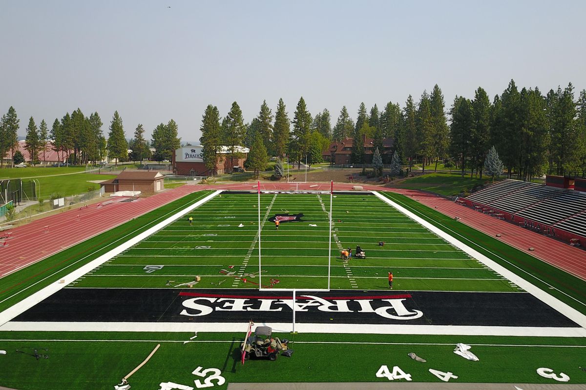 A crew puts the finishing touches on the new turf being installed in the Pine Bowl, Whitworth Universitys football field, shown Sunday, Aug. 6, 2017. (Jesse Tinsley / The Spokesman-Review)