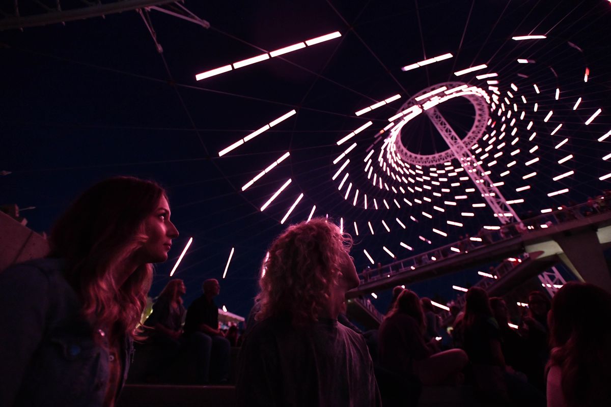 Alona Zelepukhina, left, and her brother Andrey Zagumennyy watch as the light show begins during the opening of the newly renovated U.S. Pavilion on Friday, Sept. 6, 2019, at Riverfront Park in Spokane, Wash. (Tyler Tjomsland / The Spokesman-Review)